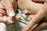 A diabetic injects herself with insulin