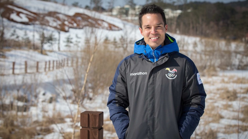 Klaus Jungbluth Rodriguez smiling while wearing his Ecuador uniform in the snow in Pyeonchang.