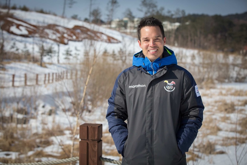 Klaus Jungbluth Rodriguez smiling while wearing his Ecuador uniform in the snow in Pyeonchang.