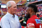 Wayne Bennett shakes hands with Hamiso Tabuai-Fidow after the Dolphins' won their NRL debut match.