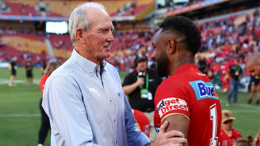 Wayne Bennett shakes hands with Hamiso Tabuai-Fidow after the Dolphins' won their NRL debut match.