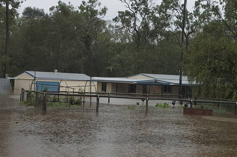 Flood waters at a house and surrounding property at Lowmead