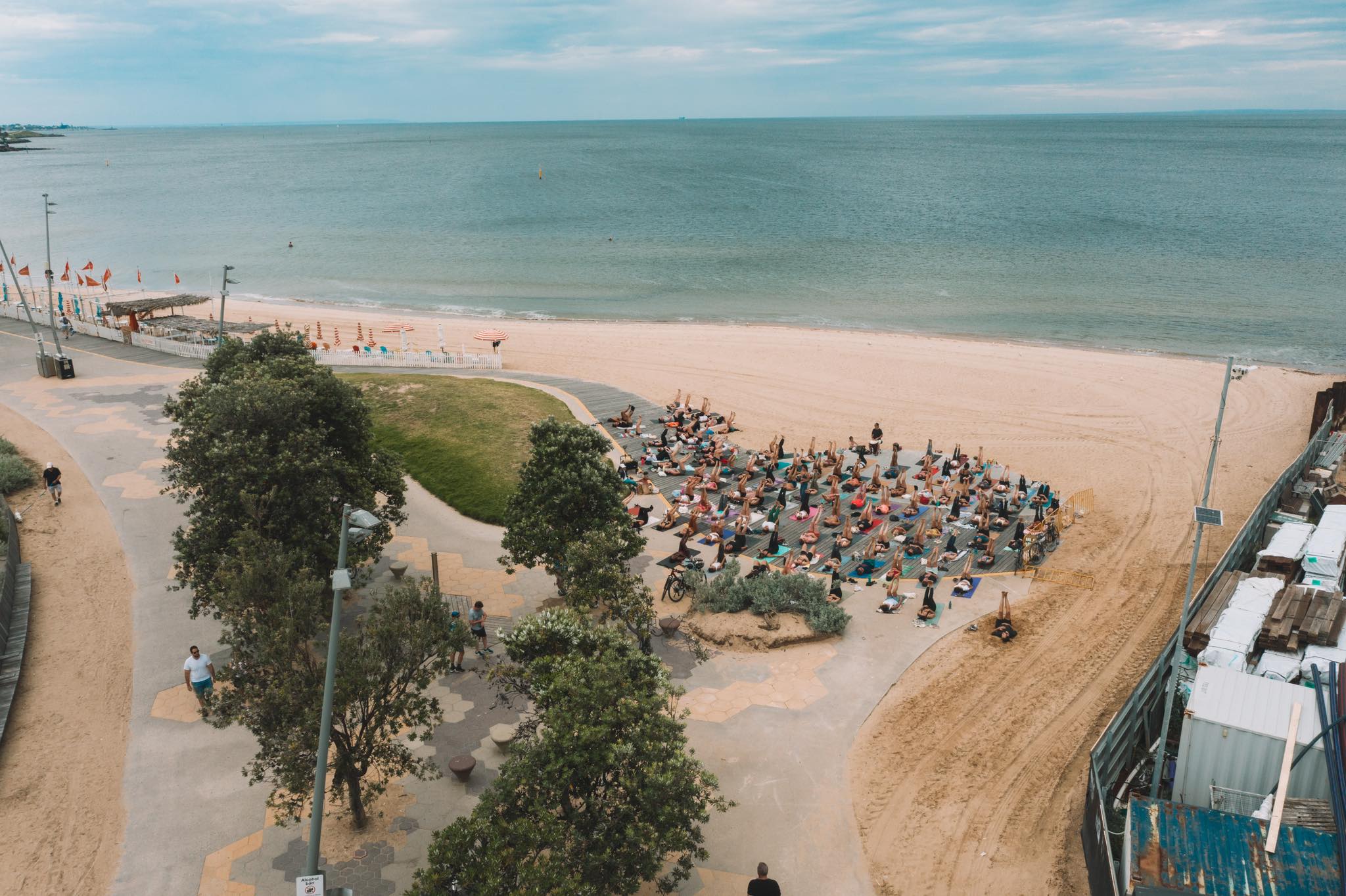 A group of people doing yoga on the beach