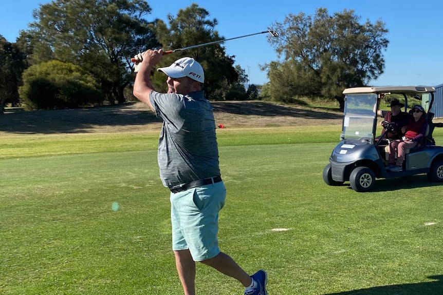 A golfer in full swing.