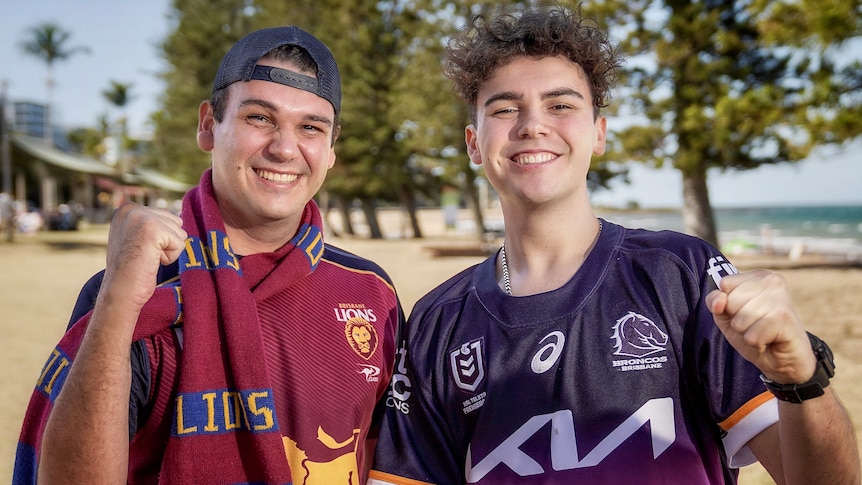 Two brothers wear Brisbane Lions and Brisbane Broncos merchandise