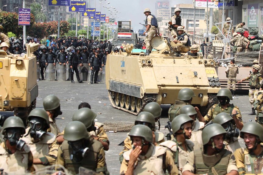 Riot police and army personnel take up position during clashes with members of the Muslim Brotherhood.