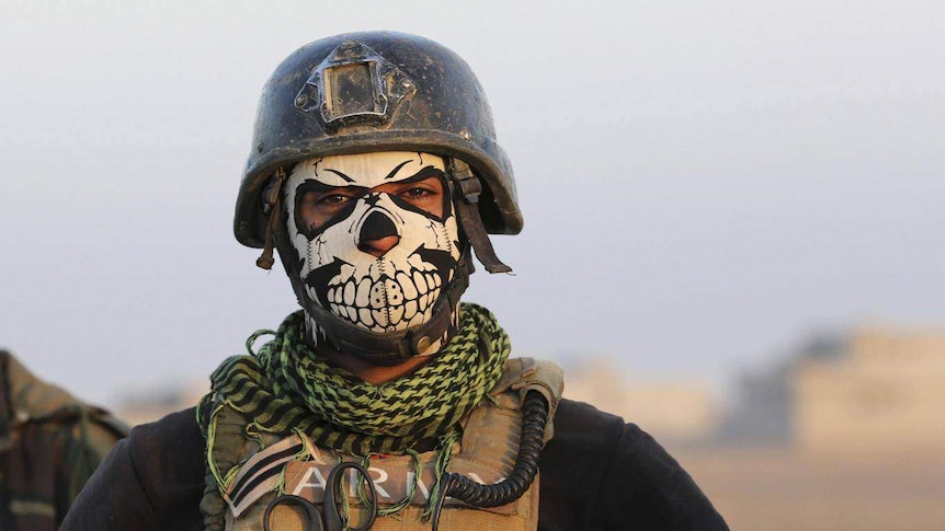 Soldier wears a skull mask.