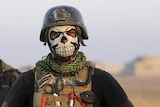 Soldier wears a skull mask.