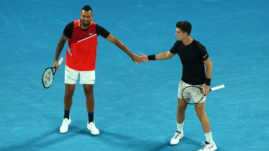Nick Kyrgios and Thanasi Kokkinakis high-five during the men's doubles final at the Australian Open.