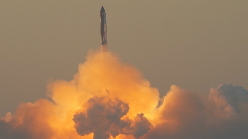 a rocket launches into the sky from a large plume of smoke 