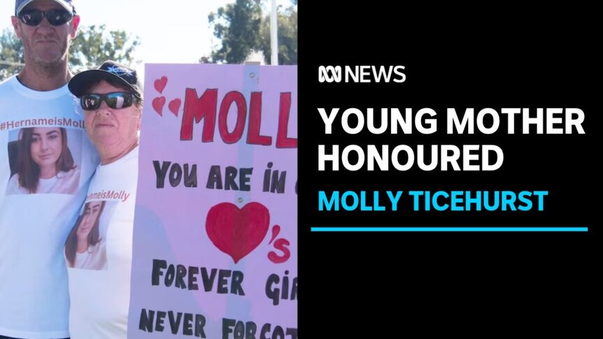 Young Mother Honoured, Molly Ticehurst: Two people with matching t-shirts hold a sign honouring Molly Ticehurst.