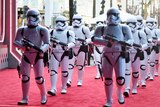 Two lines of Stormtroopers march down the red carpet at the premiere of "Star Wars: The Force Awakens".