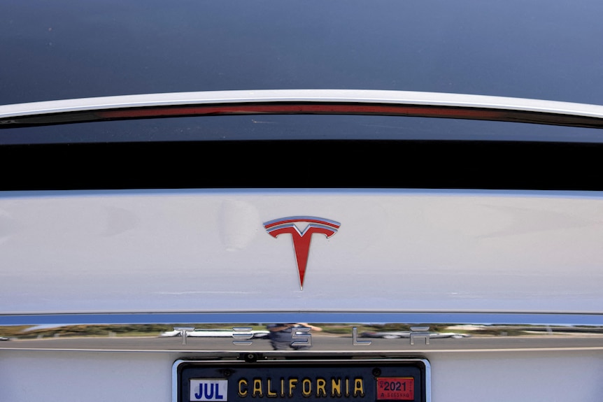 A close up of the rear of a Tesla automobile with a California number plate