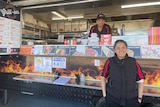 Turkish couple stand in front of their kebab foodtruck   