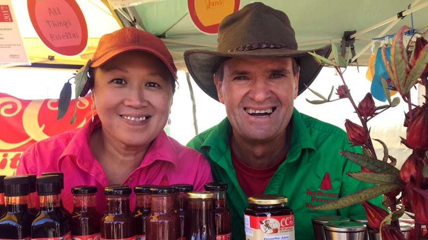 Two people sitting at their stall that sells rosella products