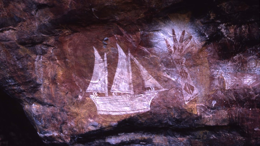 A ship and painted hand stencil near the East Alligator River