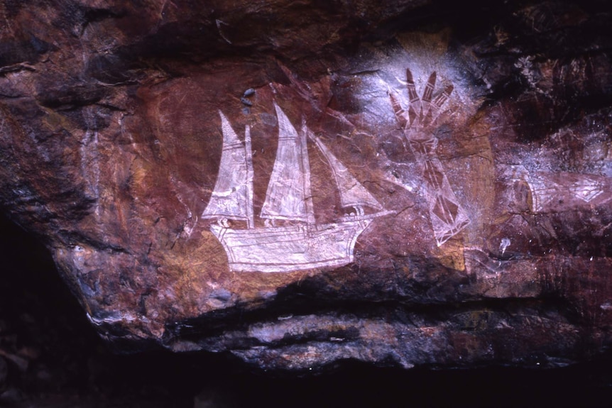 A ship and painted hand stencil near the East Alligator River