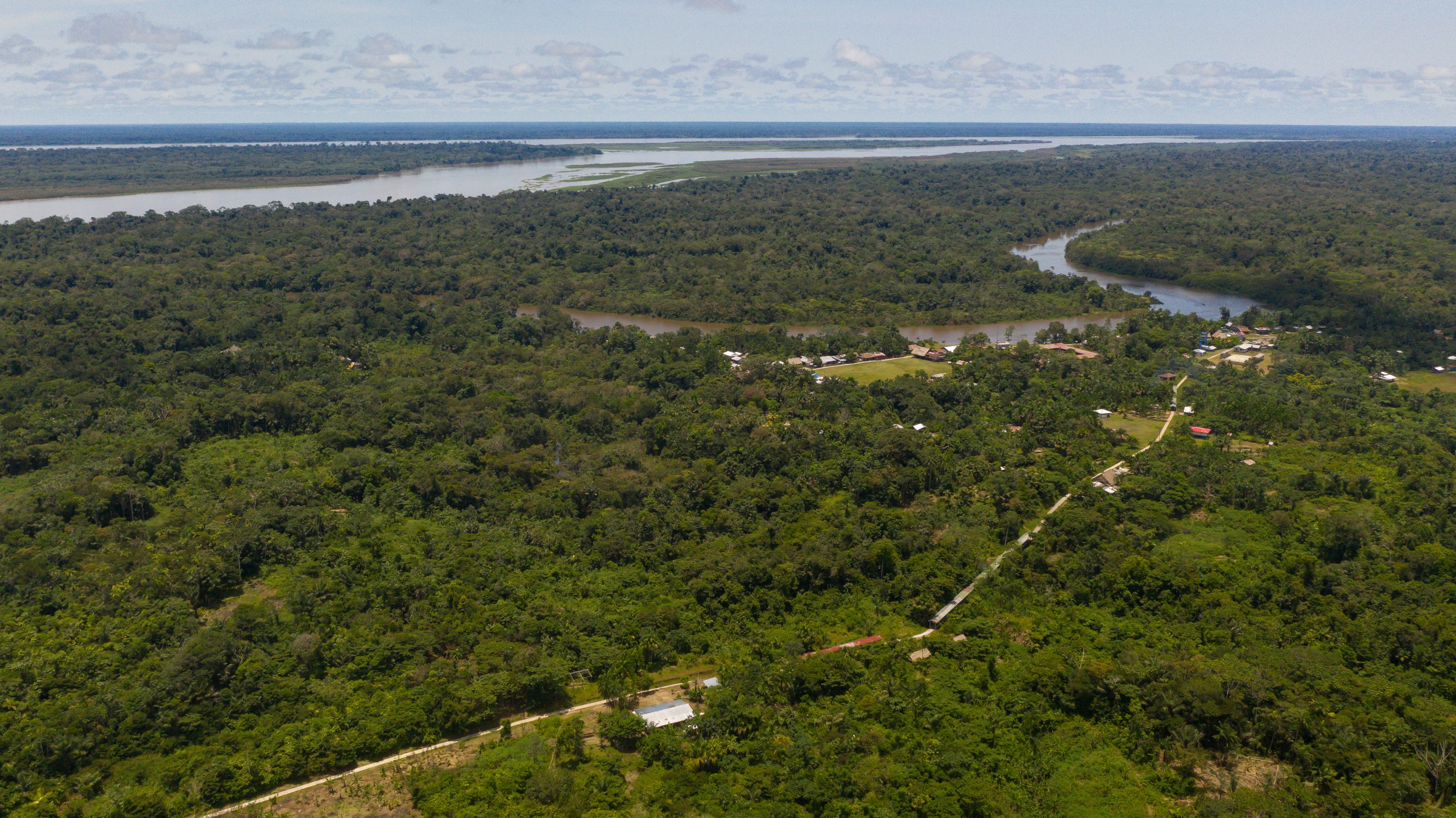 An aerial shot of a river surrounded by rainforest.
