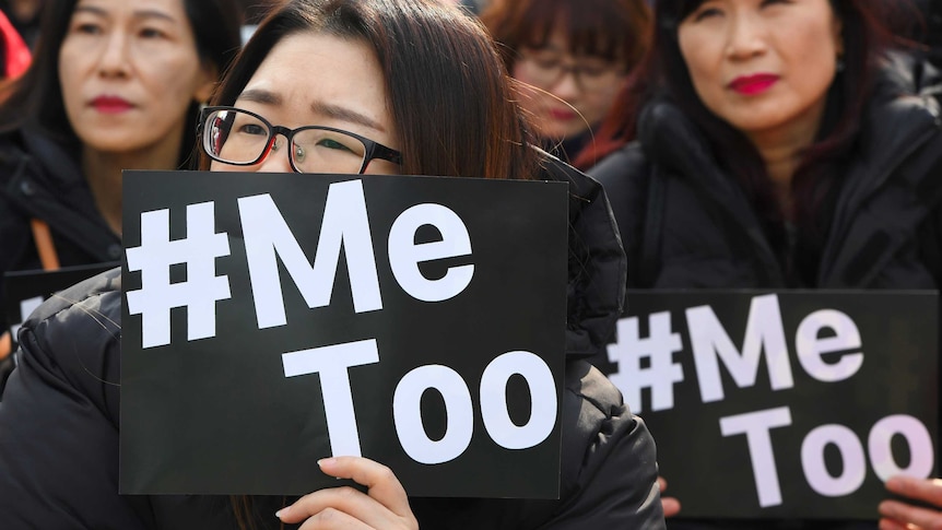 South Korean women holding up placards saying #MeToo.