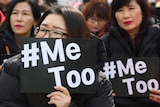 South Korean women holding up placards saying #MeToo.