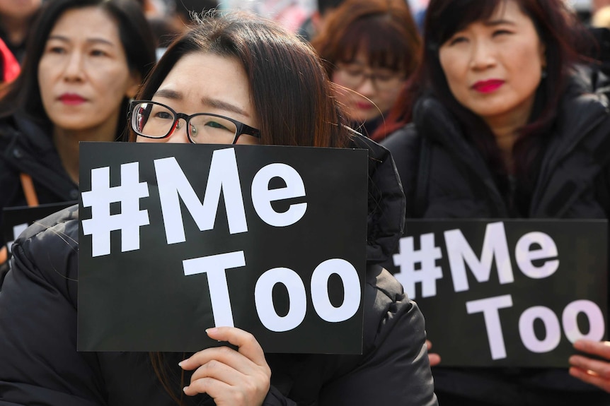 South Korean women holding up placards saying #MeToo