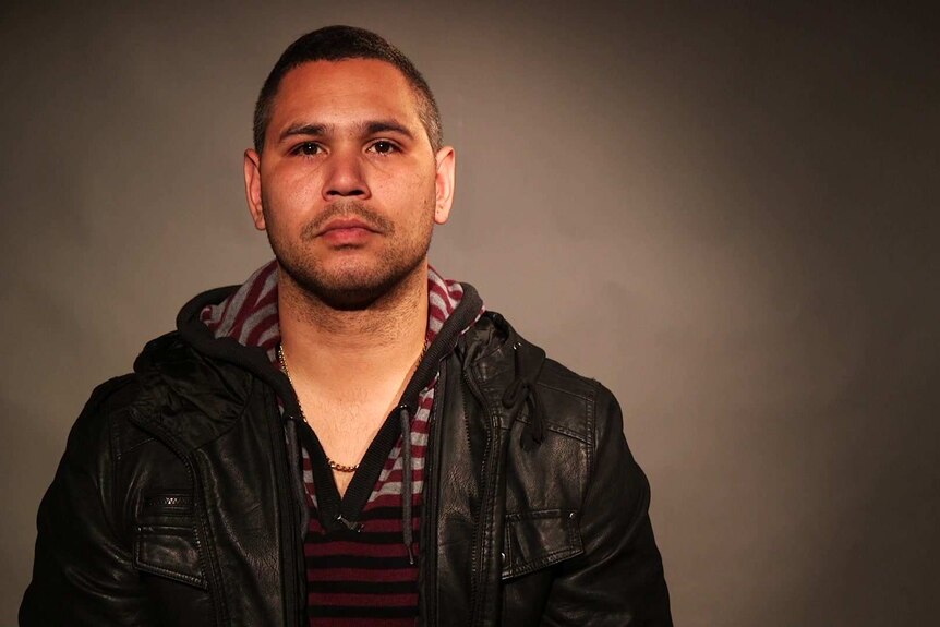 shot of Keenan Mundine, neutral expression, looking straight into the camera. He's wearing a leather jacket.