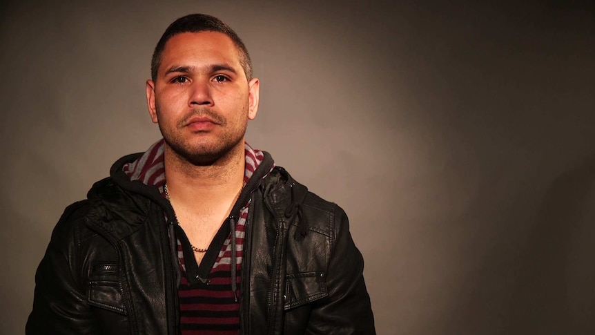 shot of Keenan Mundine, neutral expression, looking straight into the camera. He's wearing a leather jacket.