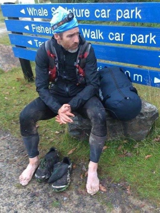 Stephen Rae kicks off his shoes after the two-day run in south-west Tasmania.