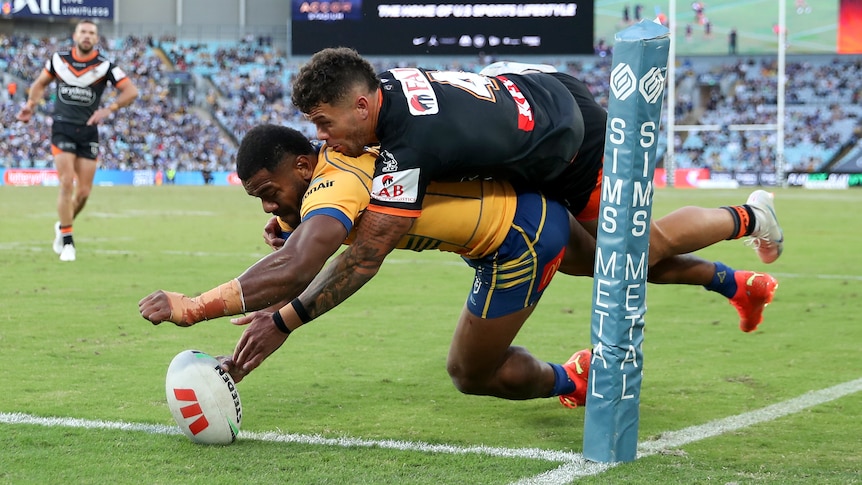Maiko Sivo lunges over the try line with the ball as a Tigers player attempts to tackle him. Maiko Sivo lunges over the try line with the ball as a Tigers player attempts to tackle him.
