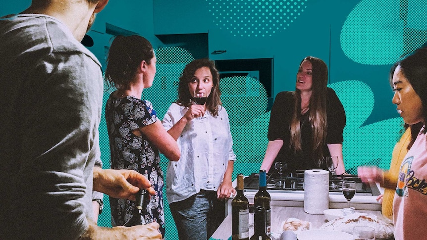 A group of people stand around a kitchen having drinks and making food for a story about why people share in their 30s