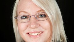 Profile picture of woman with blonde hair, wearing glasses