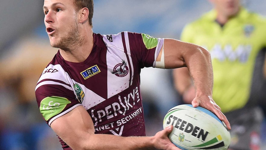 Daly Cherry-Evans, wearing a jersey with the Kaspersky logo, makes a pass in an NRL match in 2015.