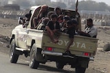 Militants sit in the back of a Toyota ute