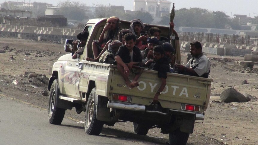 Militants sit in the back of a Toyota ute