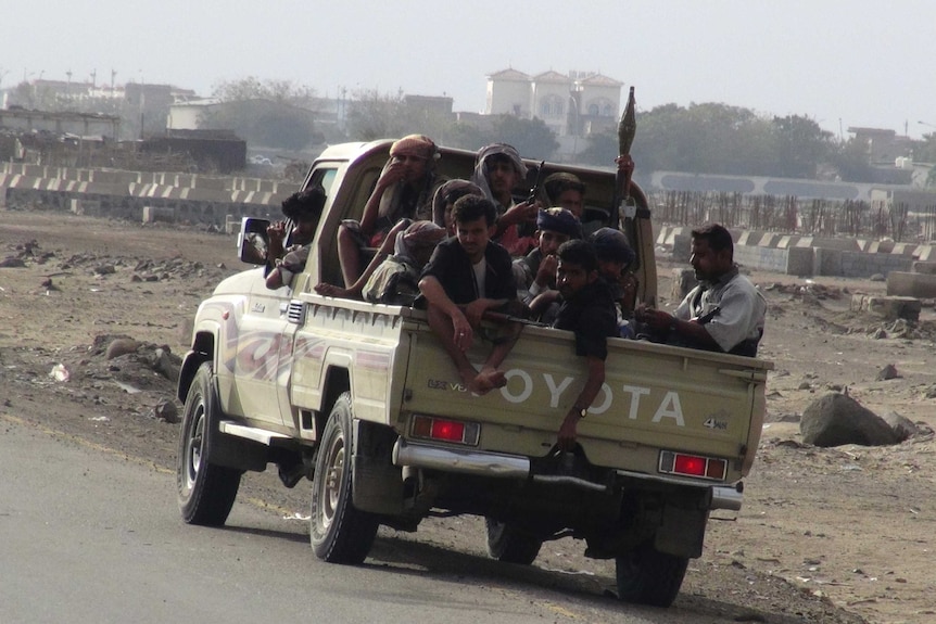 Militants sit in the back of a Toyota ute