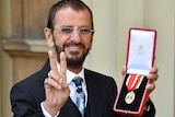 Ringo Starr, whose real name is Richard Starkey, poses after receiving his Knighthood.