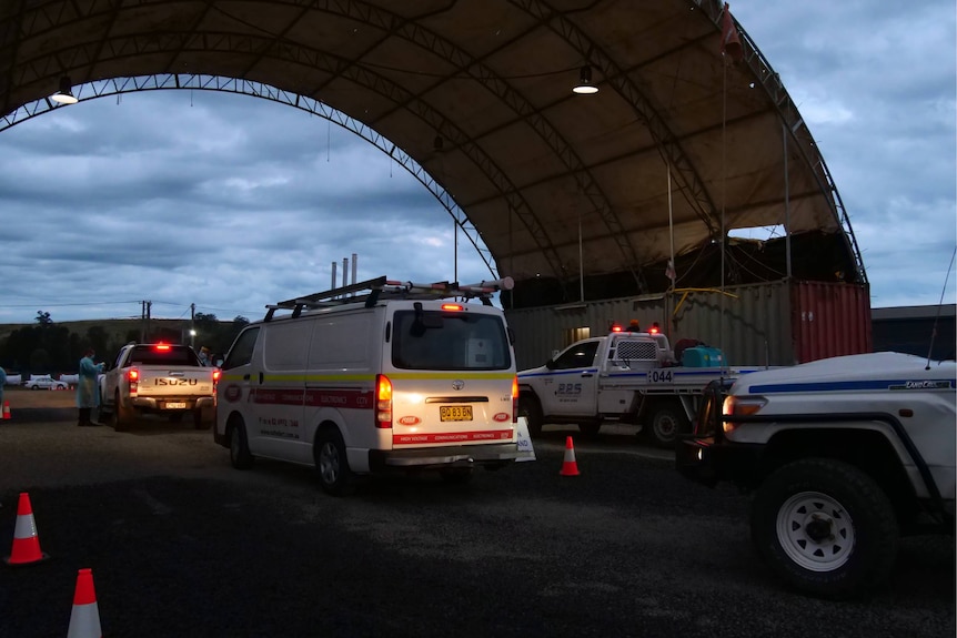 cars queue at a covid testing clinic