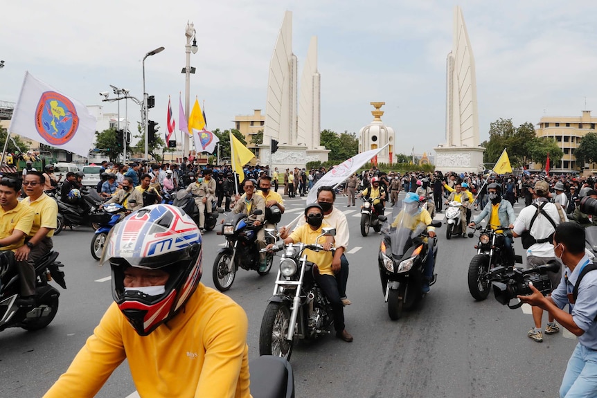 Anti-government protesters parade on motorcycles during a rally near the Democracy Monument.