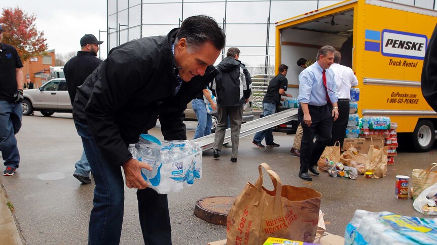 Republican presidential nominee Mitt Romney loads relief supplies in Ohio for people affected by superstorm Sandy.