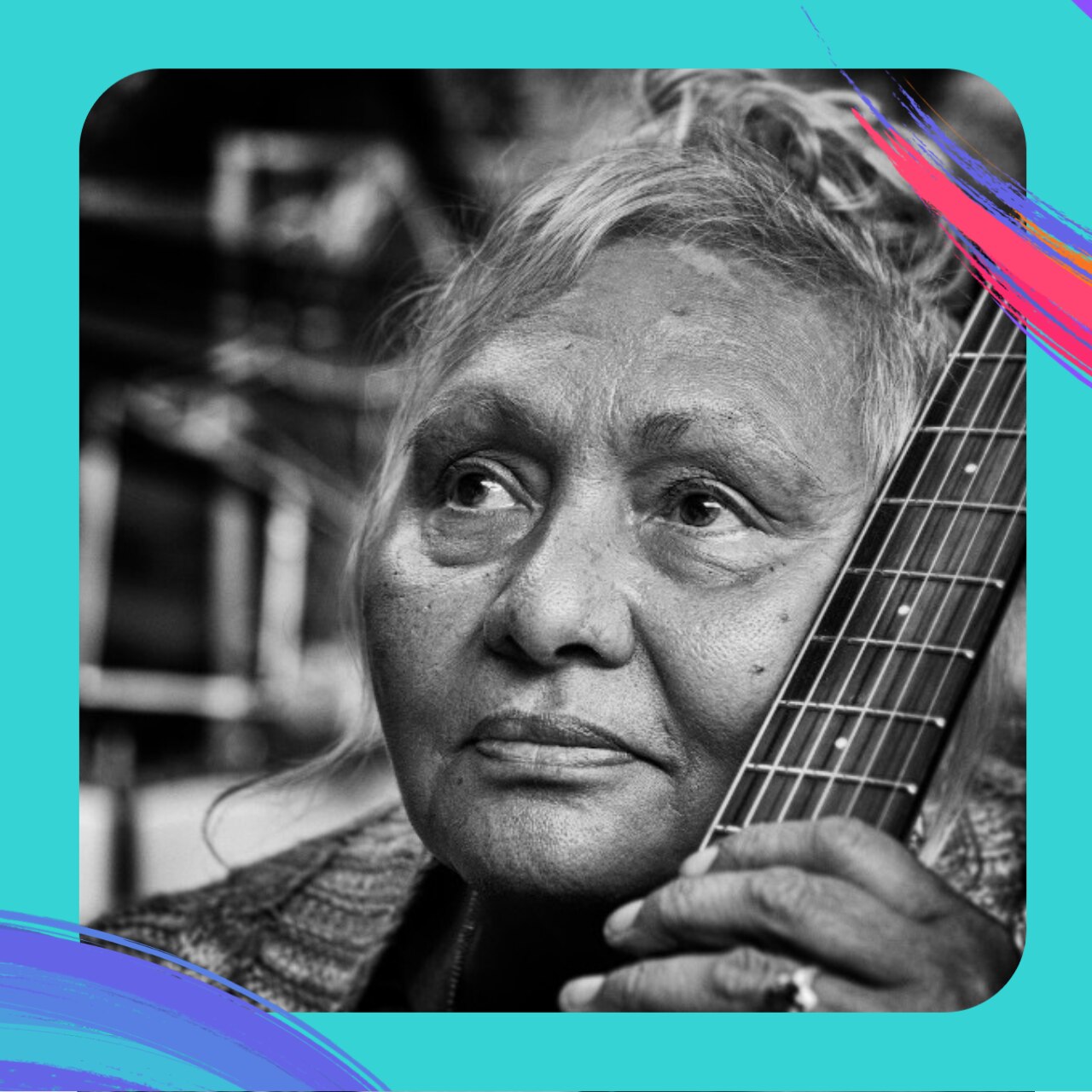 A black and white portrait of Aunty Rhonda, holding her guitar.