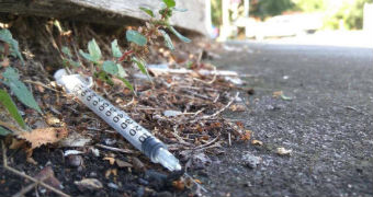 A used needle in a Richmond gutter