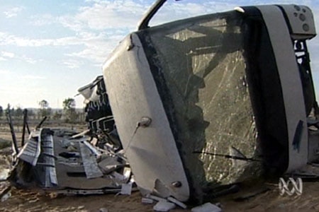 A bus that has crashed on its side.