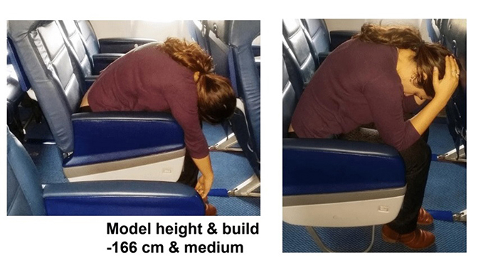 Woman attempting to brace awkwardly in a small plane seat.