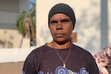 a young aboriginal woman wearing a black headband