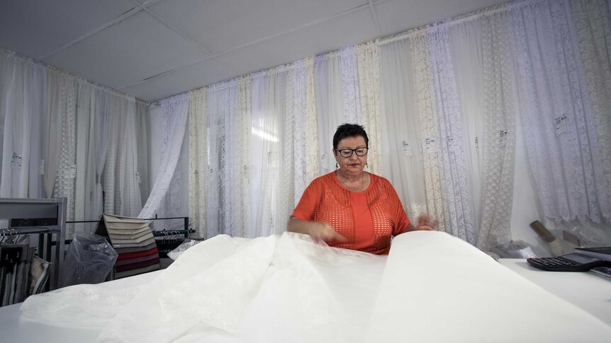 A woman in a curtain shop.
