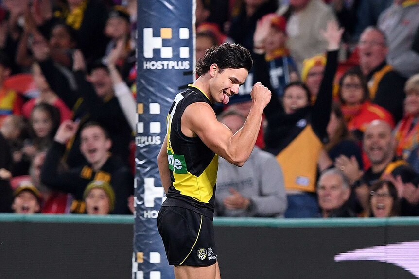 Daniel Rioli pumps his fist and sticks his tongue out in celebration of a goal for Richmond.
