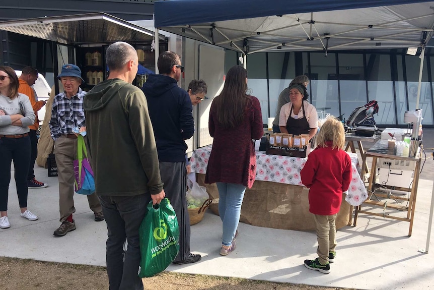 Shoppers queue at a stall at the Southside Markets in Canberra, April 2016.