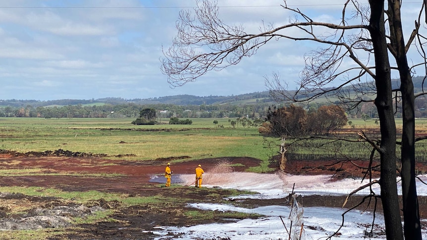 Firefighters spraying foam on a peat fire in Sarsfield.