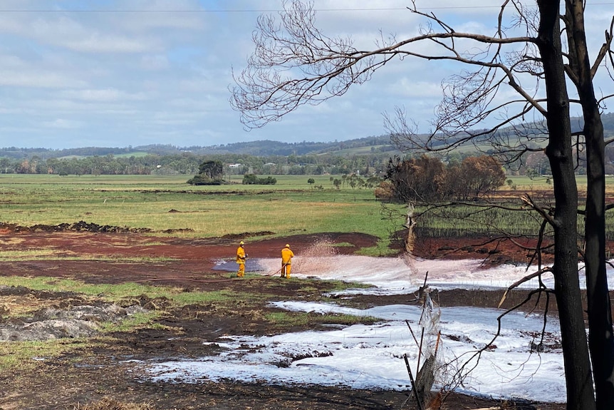 Firefighters spraying foam on a peat fire in Sarsfield.