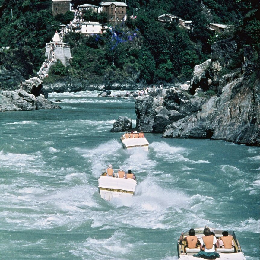 three jet boats battling their way up rapids in a gorge in Northern India